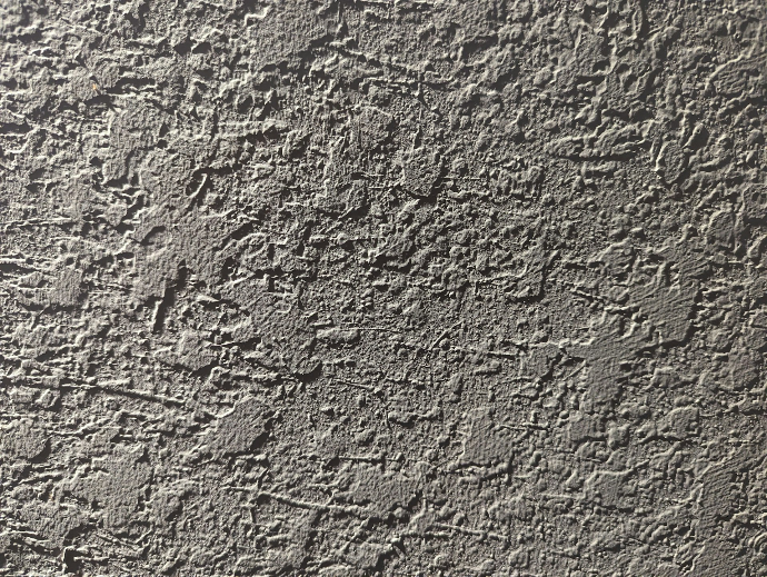 a close up of a cement wall with cracks